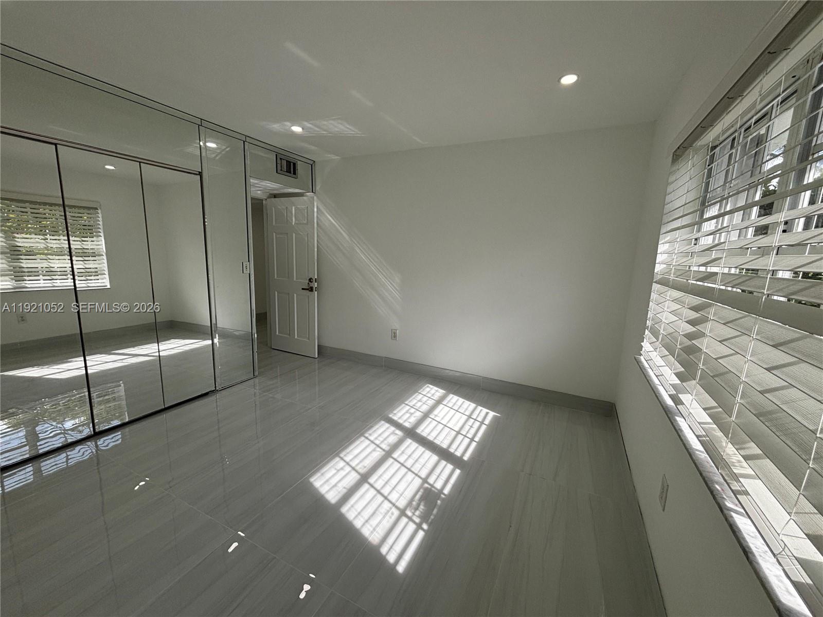 725 91st Street Surfside, FL 33154 - Photo 23 of 32 a view of an empty room and window