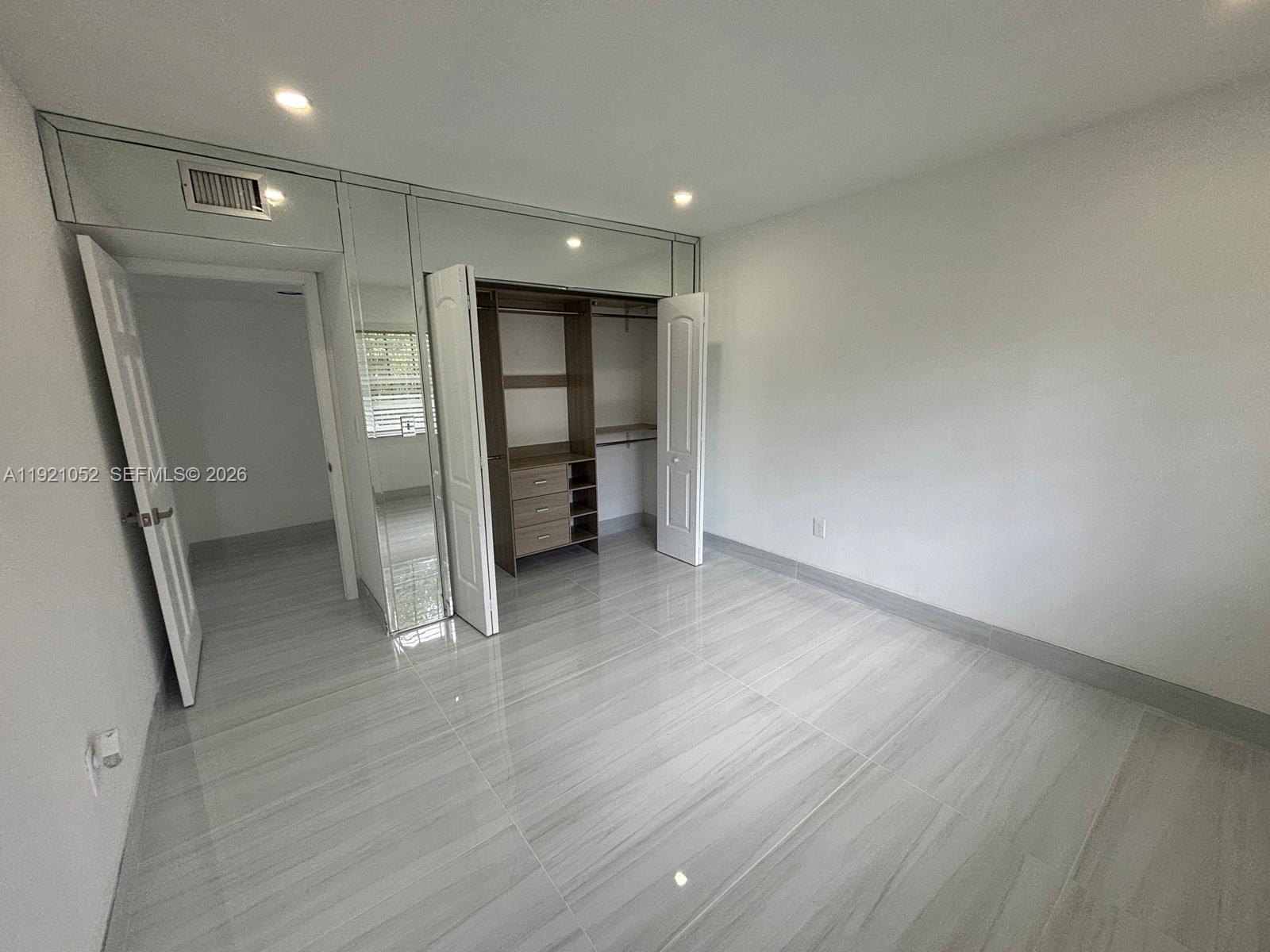 725 91st Street Surfside, FL 33154 - Photo 26 of 32 wooden floor in an empty room with a window