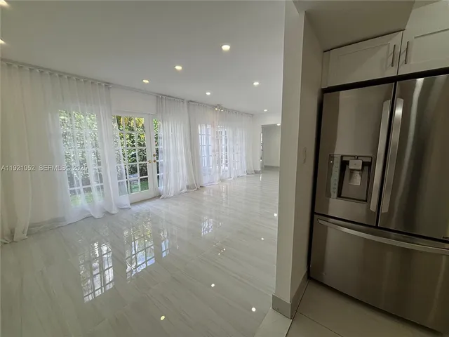a view of an empty room with a kitchen