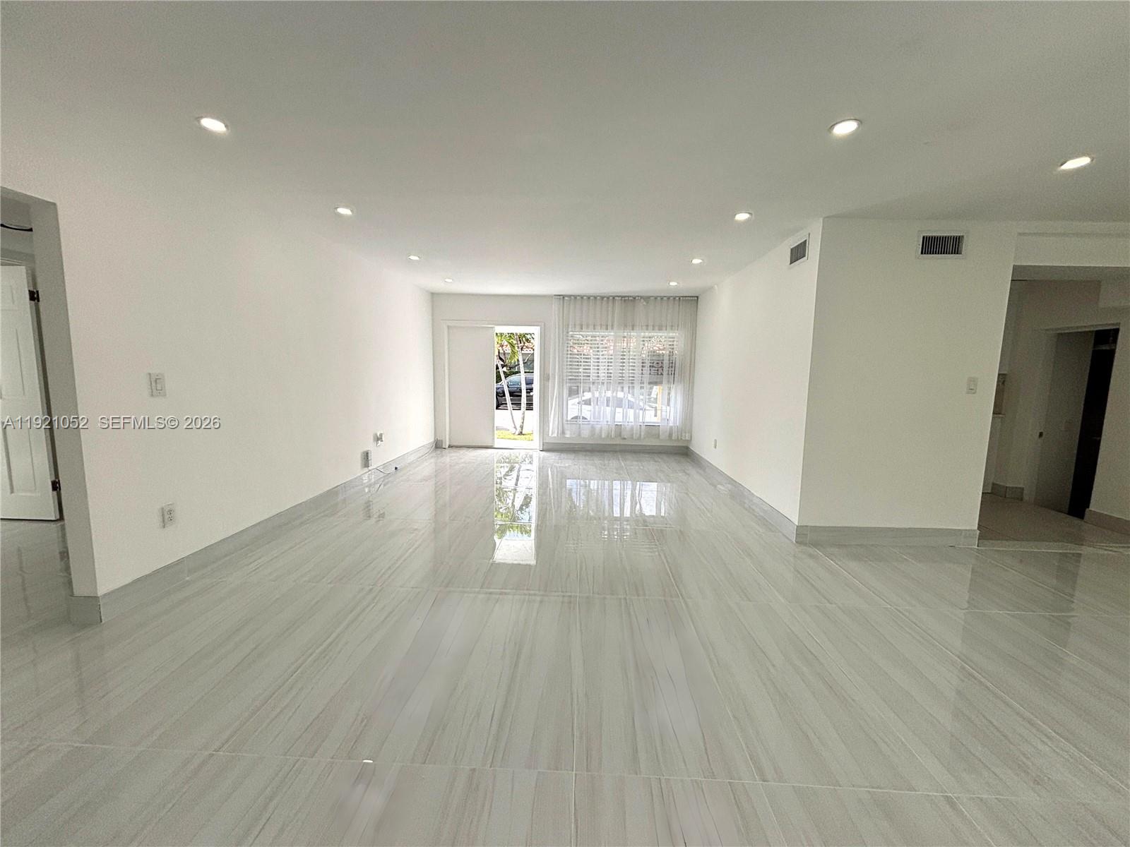 725 91st Street Surfside, FL 33154 - Photo 8 of 32 a view of empty room with wooden floor and fan