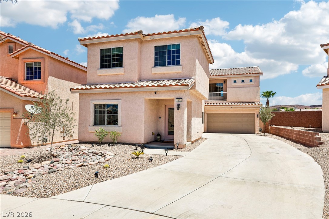 1176 Butternut Ranch Court Henderson, NV 89052 - Photo 3 of 60 A terracotta-tiled roof crowns this desert dwelling with a welcoming front entrance and attached garage.