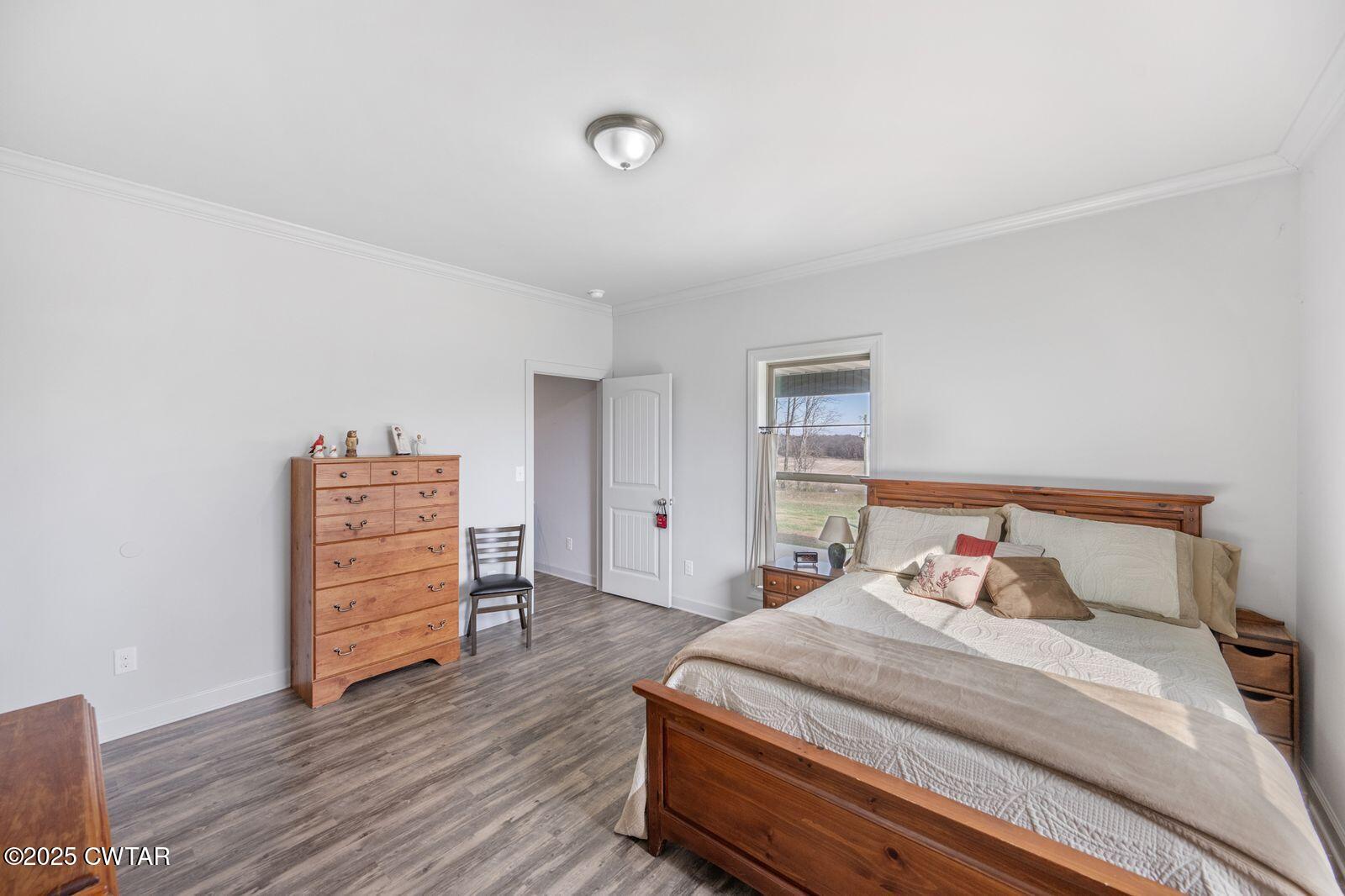 96 Highway 200 Luray, TN 38352 - Photo 11 of 44 a bedroom with a bed and wooden floor