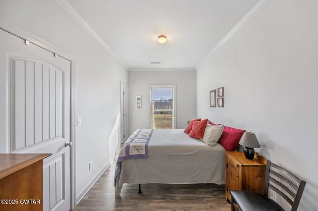 a bedroom with a bed and a painting on the wall