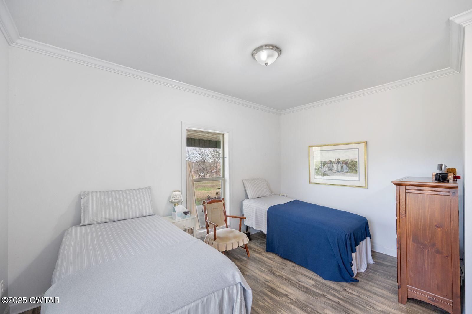 96 Highway 200 Luray, TN 38352 - Photo 17 of 44 a bedroom with a bed and a painting on the wall