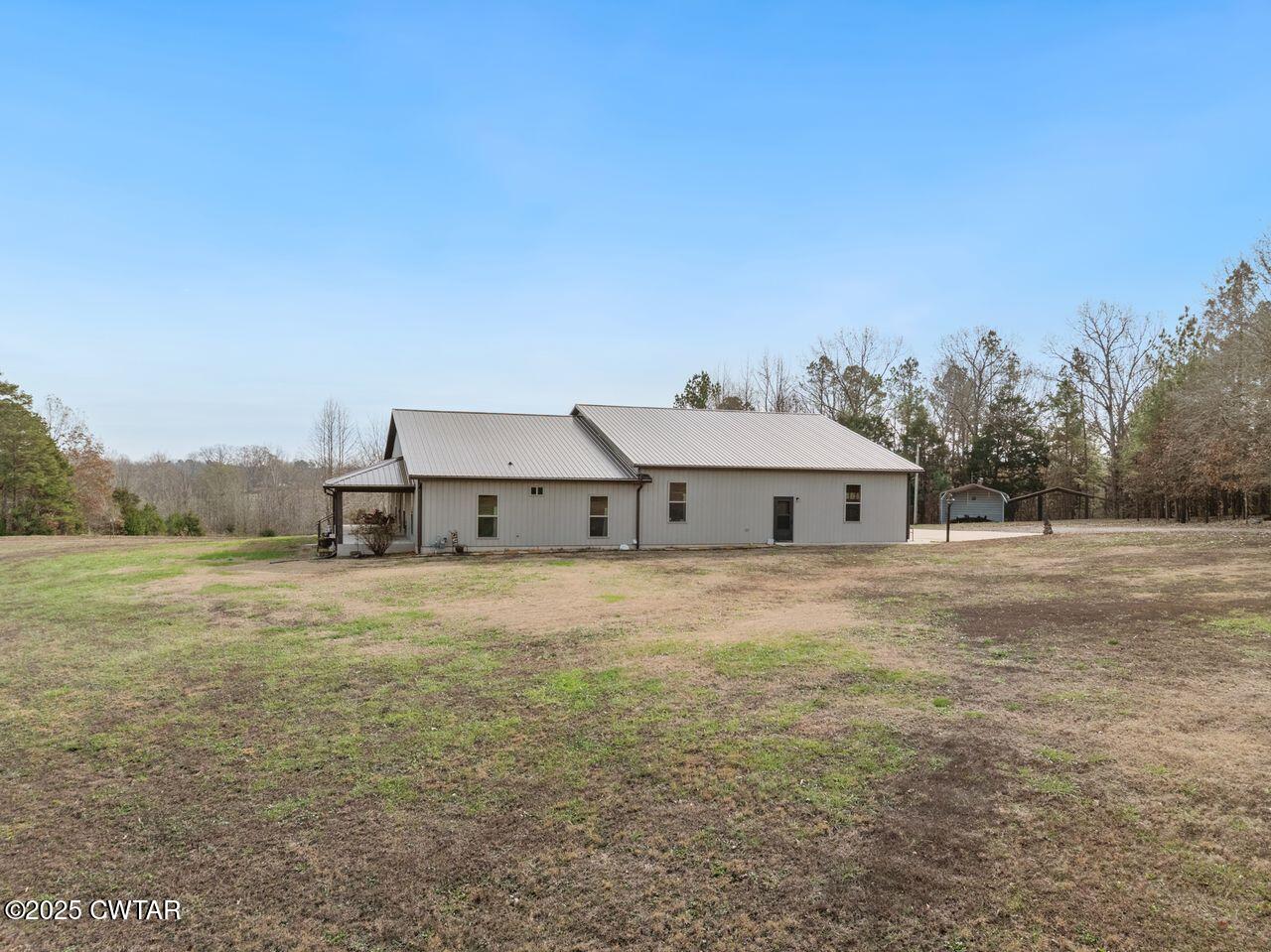 96 Highway 200 Luray, TN 38352 - Photo 34 of 44 a view of a house with a yard and garage