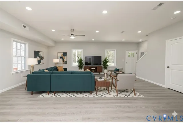 a living room with furniture window and a wooden floor
