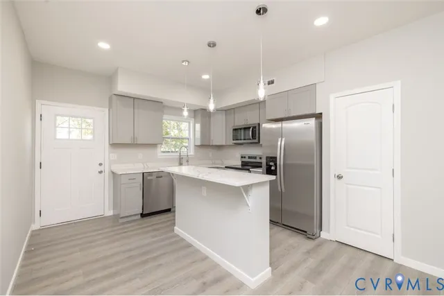 a kitchen with a refrigerator sink and cabinets