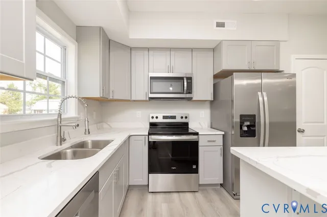 a kitchen with a sink a stove and refrigerator