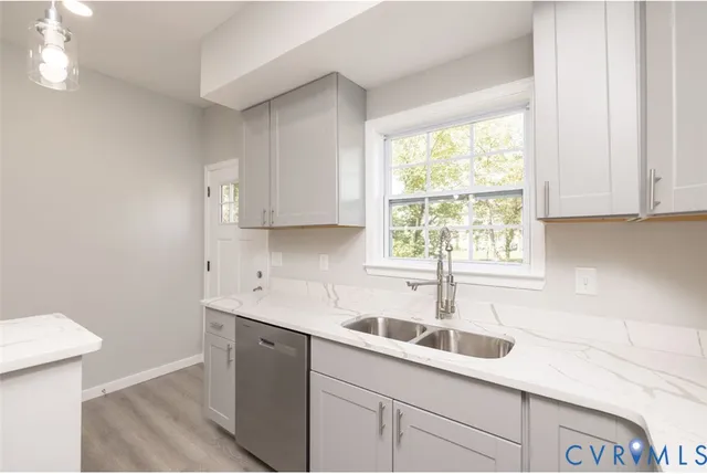 a kitchen with a sink window and cabinets