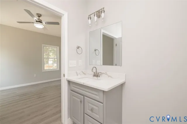 a bathroom with a sink vanity and a mirror