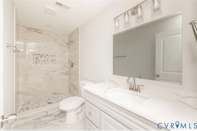 a bathroom with a sink toilet a shower and a mirror