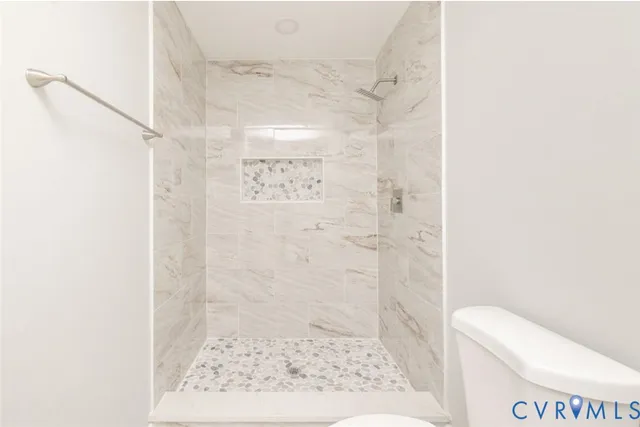 a bathroom with a shower and toilet