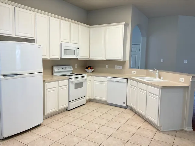 a kitchen with kitchen island a sink stainless steel appliances and cabinets