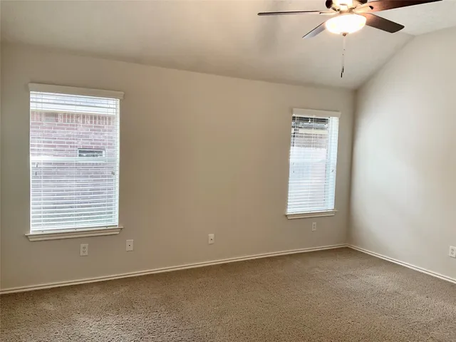 an empty room with windows and closet