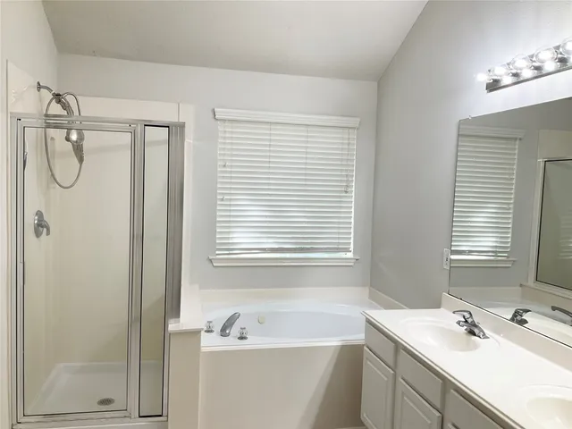 an empty room with a window and a ceiling fan