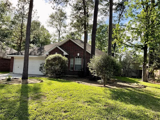a view of a house with a yard table and chairs