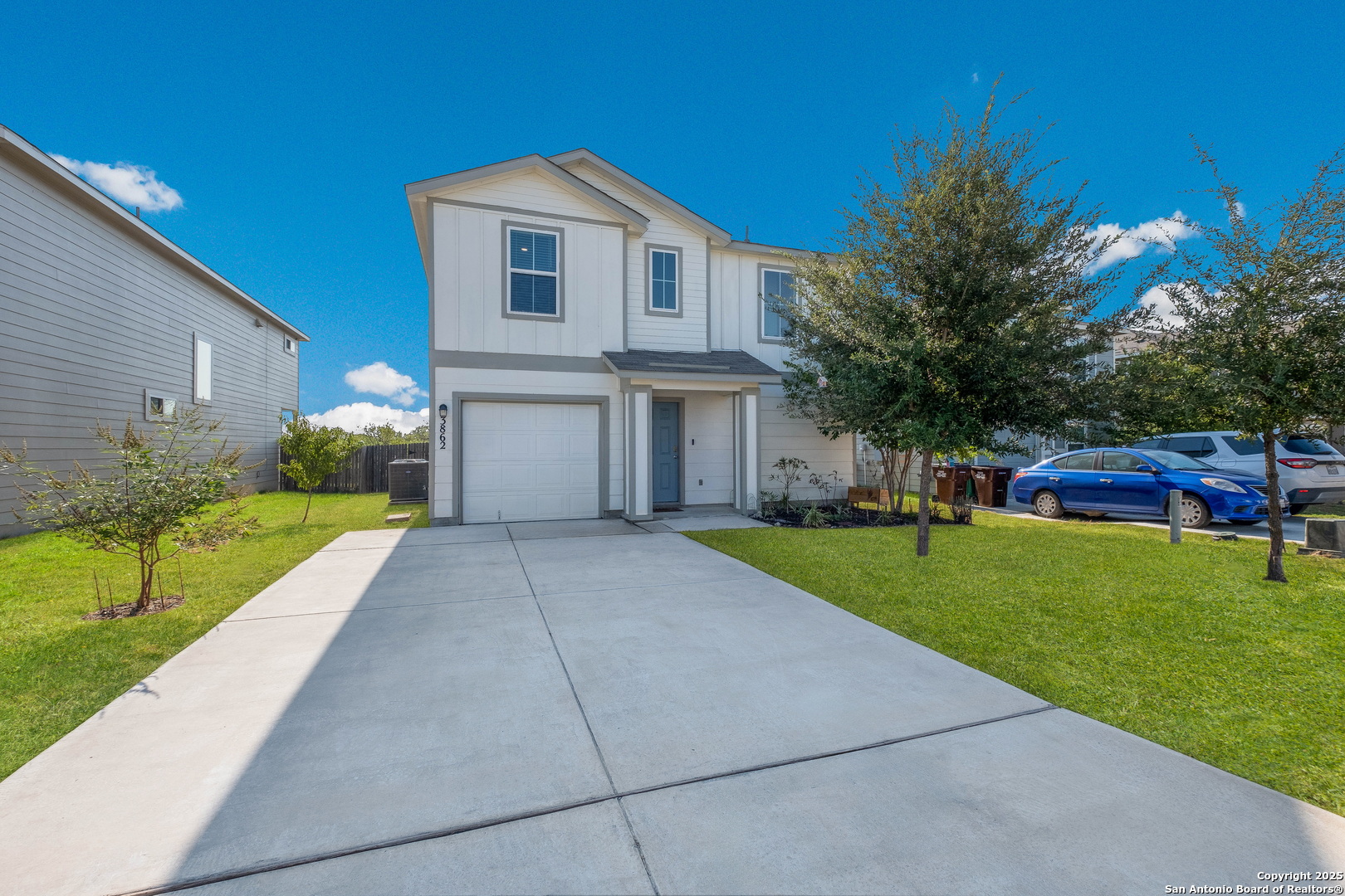 a front view of house with yard and green space