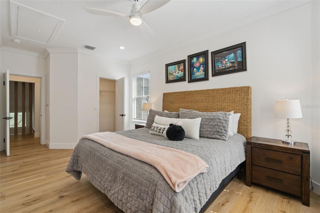 908 Croton Road Celebration, FL 34747 - Photo 36 of 86 a bedroom with a bed and a lamp