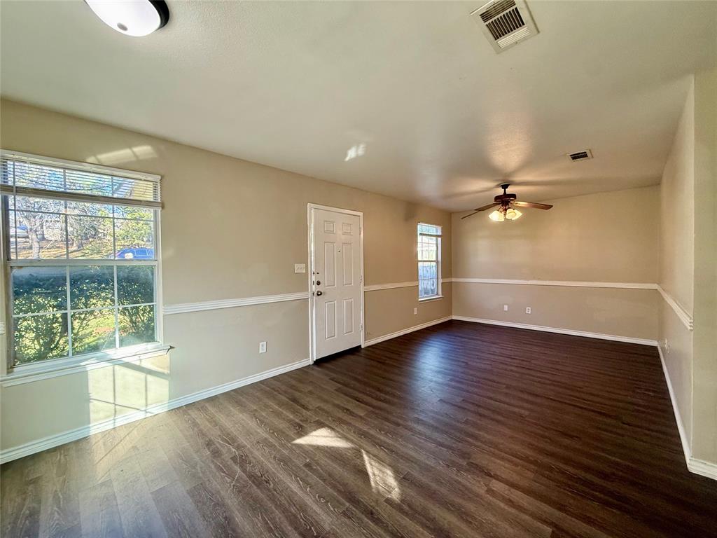 104 East Prospect Street Denison, TX 75021 - Photo 3 of 12 wooden floor in an empty room with a window
