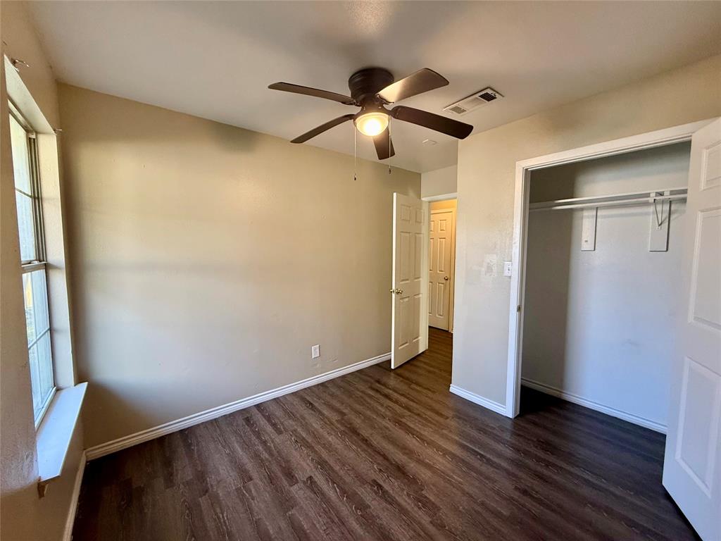 104 East Prospect Street Denison, TX 75021 - Photo 6 of 12 a view of an empty room with wooden floor and a window