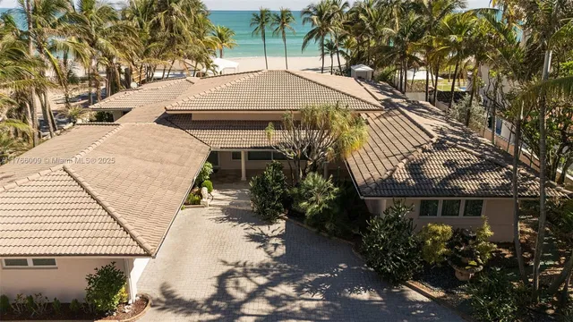 a aerial view of a house with a yard and potted plants