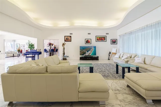 a view of a white house with a large windows and plants