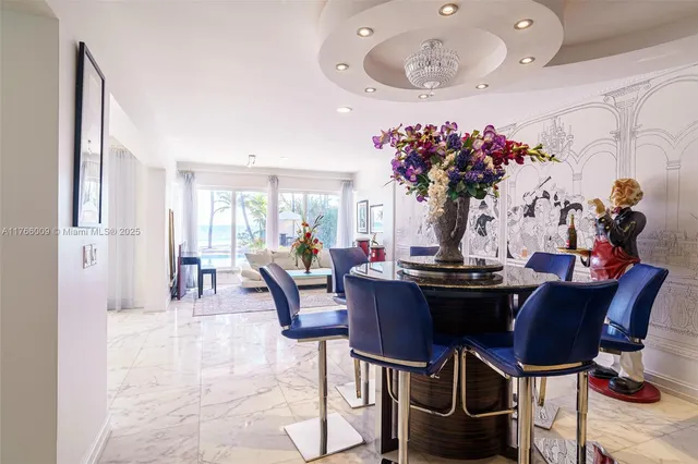 a dining room with furniture and a floor to ceiling window