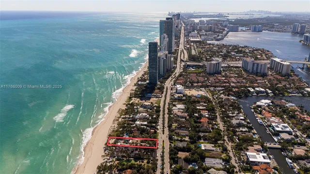 a front view of a house with yard and lake view
