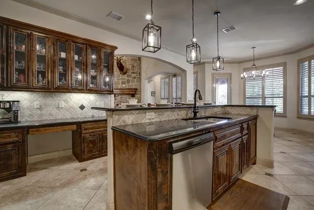 a kitchen with stainless steel appliances granite countertop a sink and a counter space