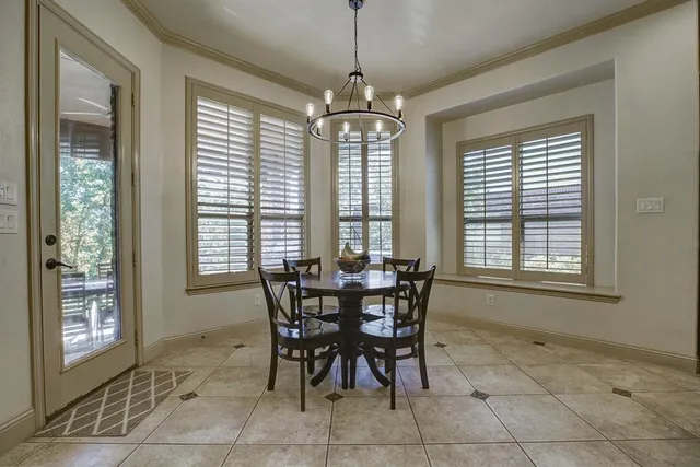 a view of a dining room with furniture and windows