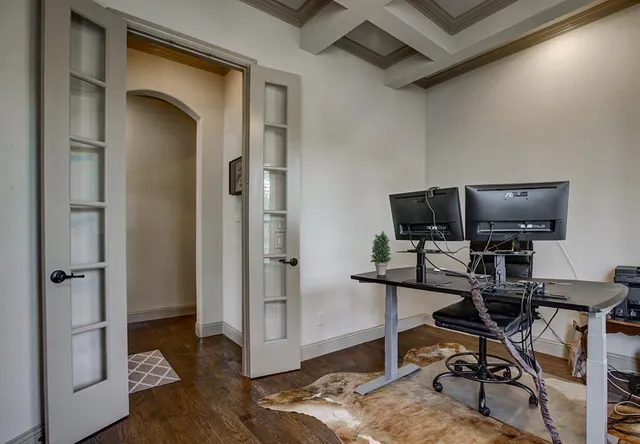 a view of a workspace with furniture and wooden floor