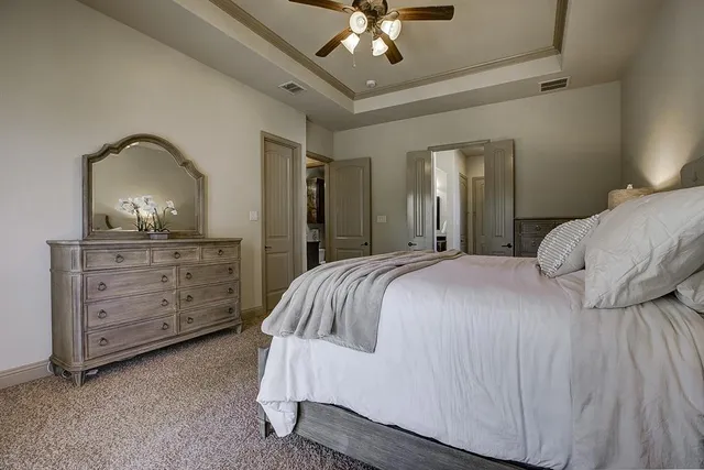 a bedroom with a bed and a dresser