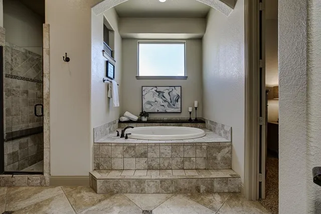 a view of bathroom with bathtub and window