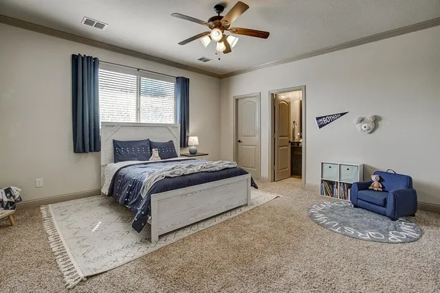 a spacious bedroom with a bed and a chandelier