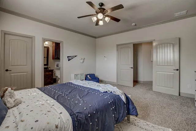 a bedroom with a bed and a chandelier