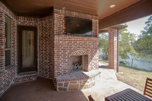 a living room with a fireplace and a flat screen tv