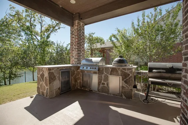 a view of a patio with chairs under an umbrella