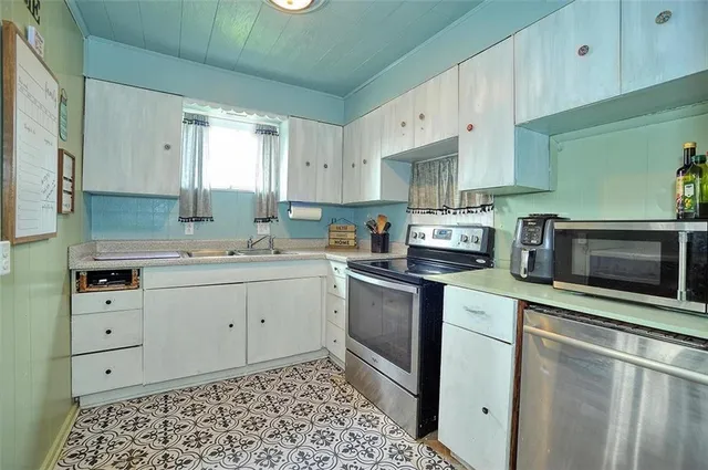 a kitchen with a sink stove and cabinets