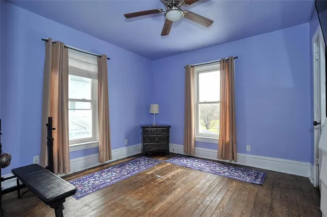 a bedroom with furniture window and wooden floor