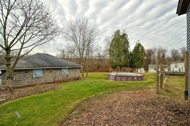 a view of a house with backyard and sitting area