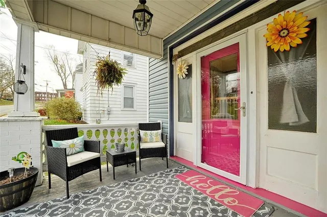 a balcony with furniture and a potted plant