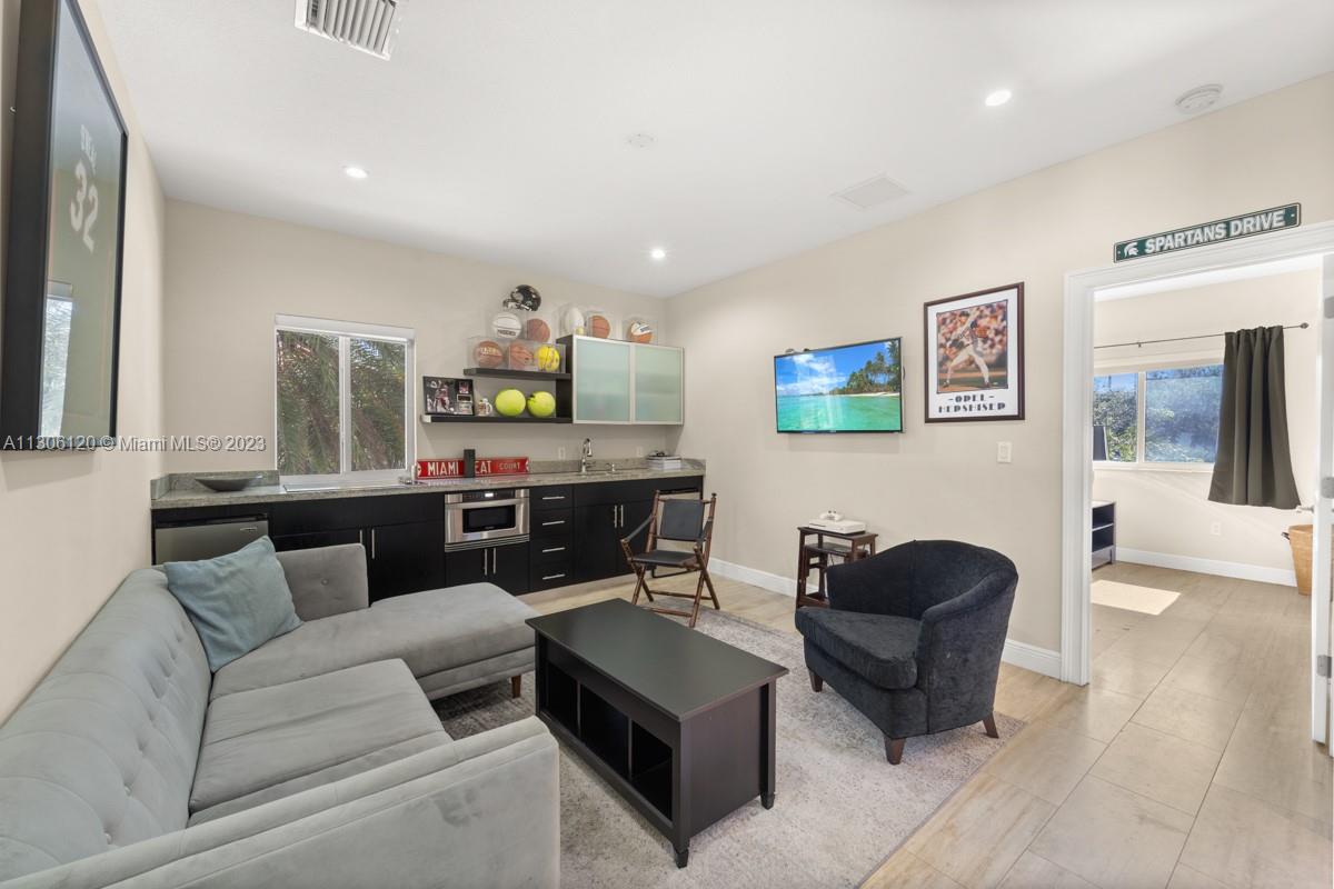 6300 Allison Road Miami Beach, FL 33141 - Photo 15 of 24 a living room with furniture and painting on the wall