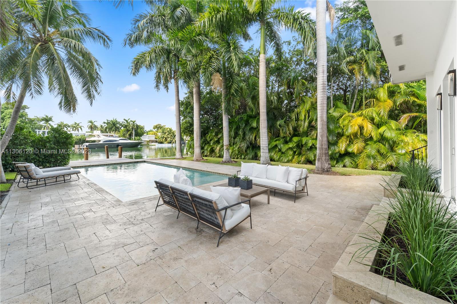 6300 Allison Road Miami Beach, FL 33141 - Photo 23 of 24 a view of swimming pool with a patio and a garden