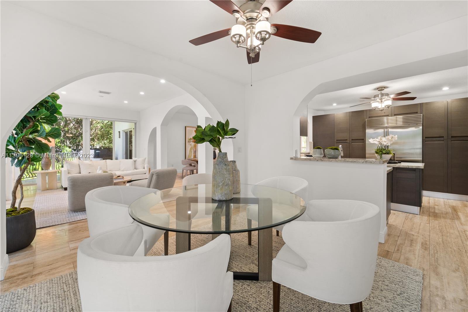 6300 Allison Road Miami Beach, FL 33141 - Photo 7 of 24 a view of a dining room with furniture and a chandelier