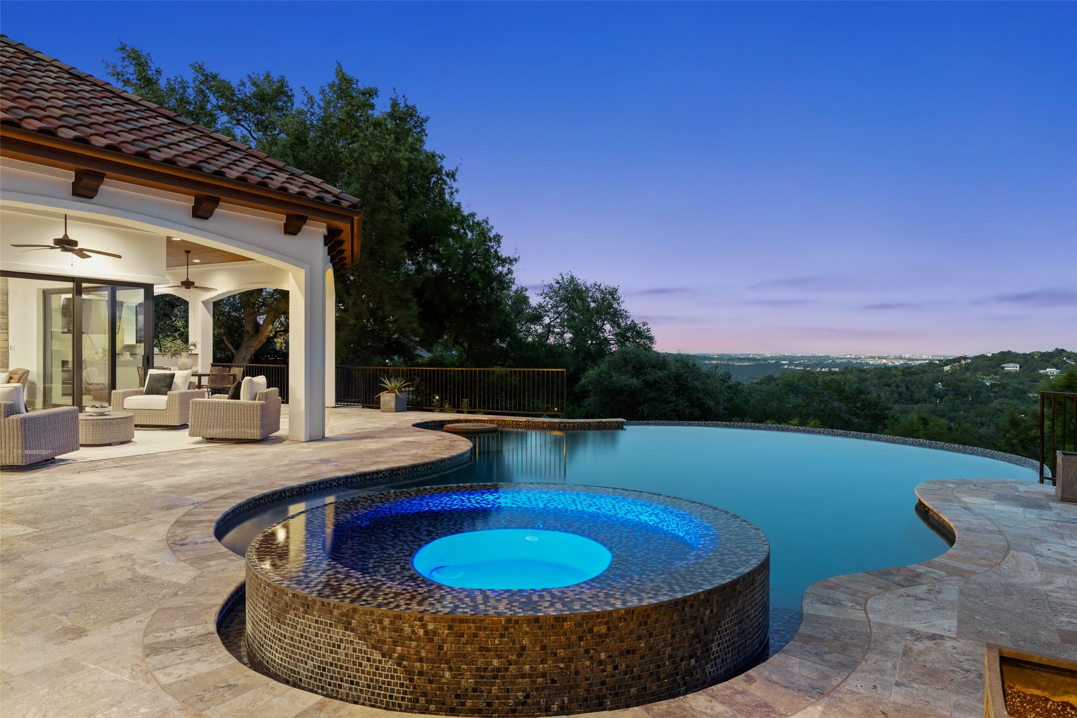 1414 The High Road Austin, TX 78746 - Photo 36 of 40 An inviting infinity pool and spa complement a sprawling patio, ideal for twilight entertaining.