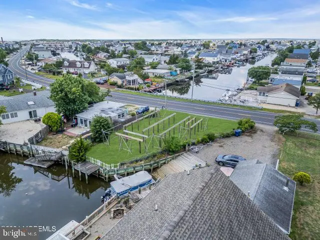 an aerial view of a house with a yard and lake view
