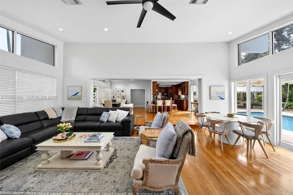 a living room with furniture wooden floor and a table