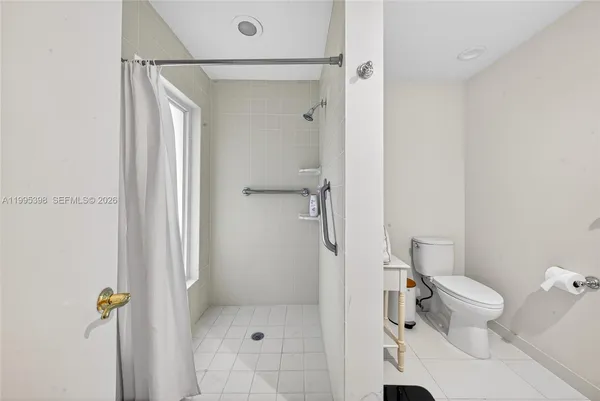 a bathroom with a shower and toilet