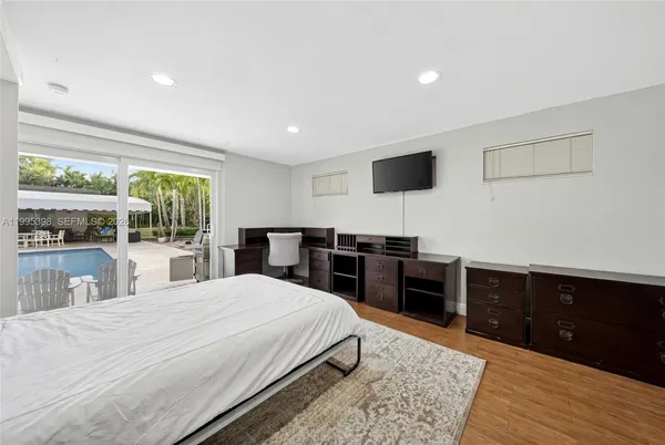 a large bedroom with a bed and a large window