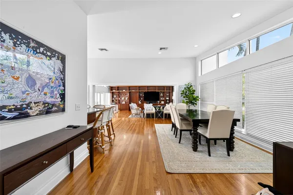 a view of a dining room with furniture and wooden floor
